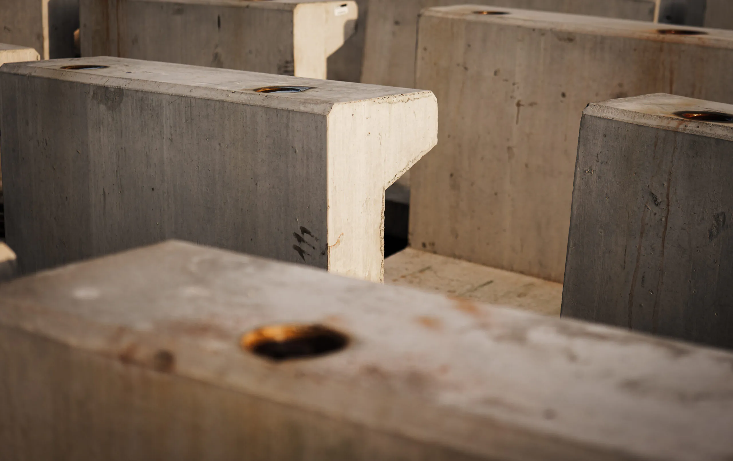 Close up of concrete blocks arranged in rows at a construction site.