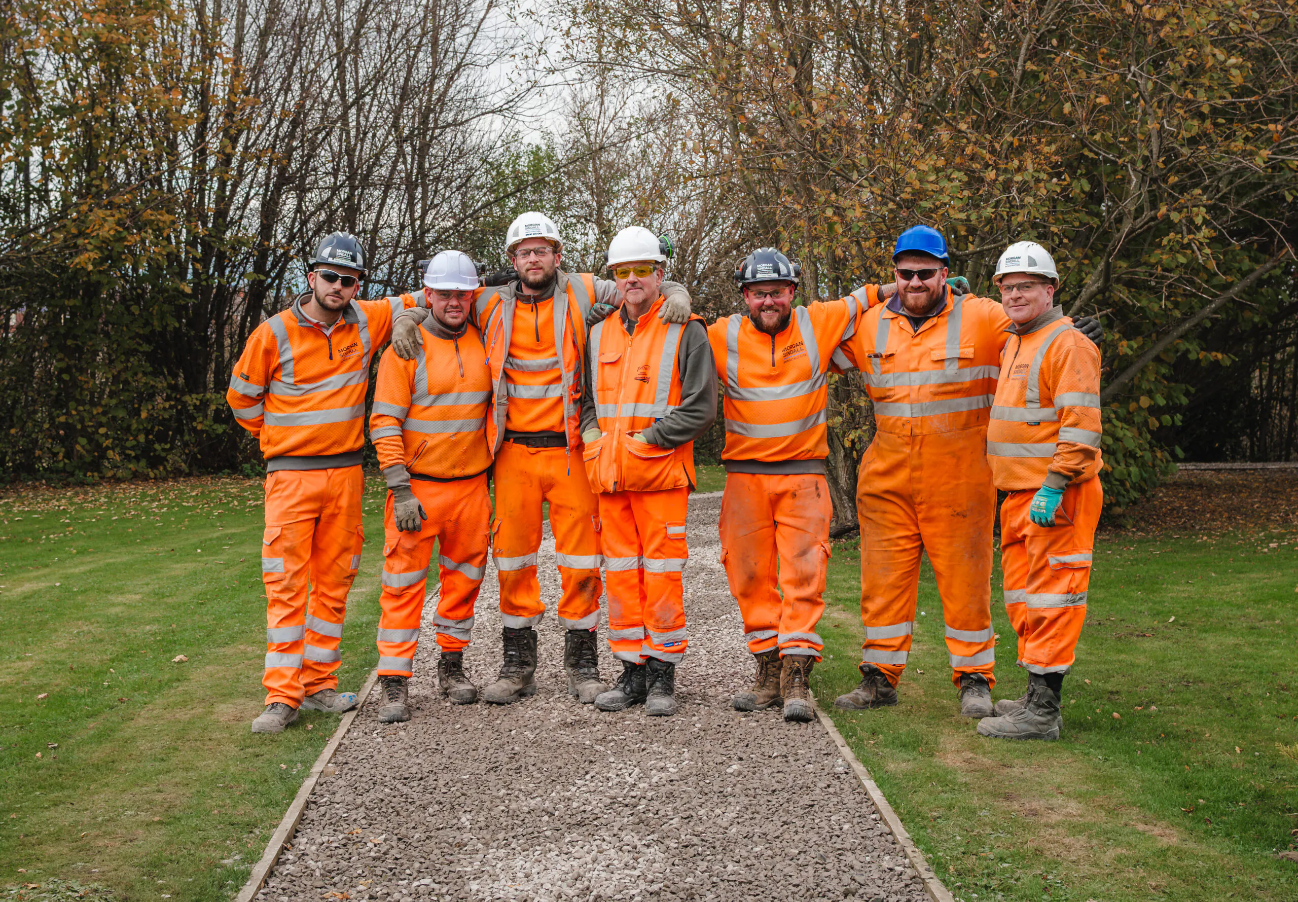 Outdoor garden scene at Burnside College showing students and staff participating in a community gardening activity.
