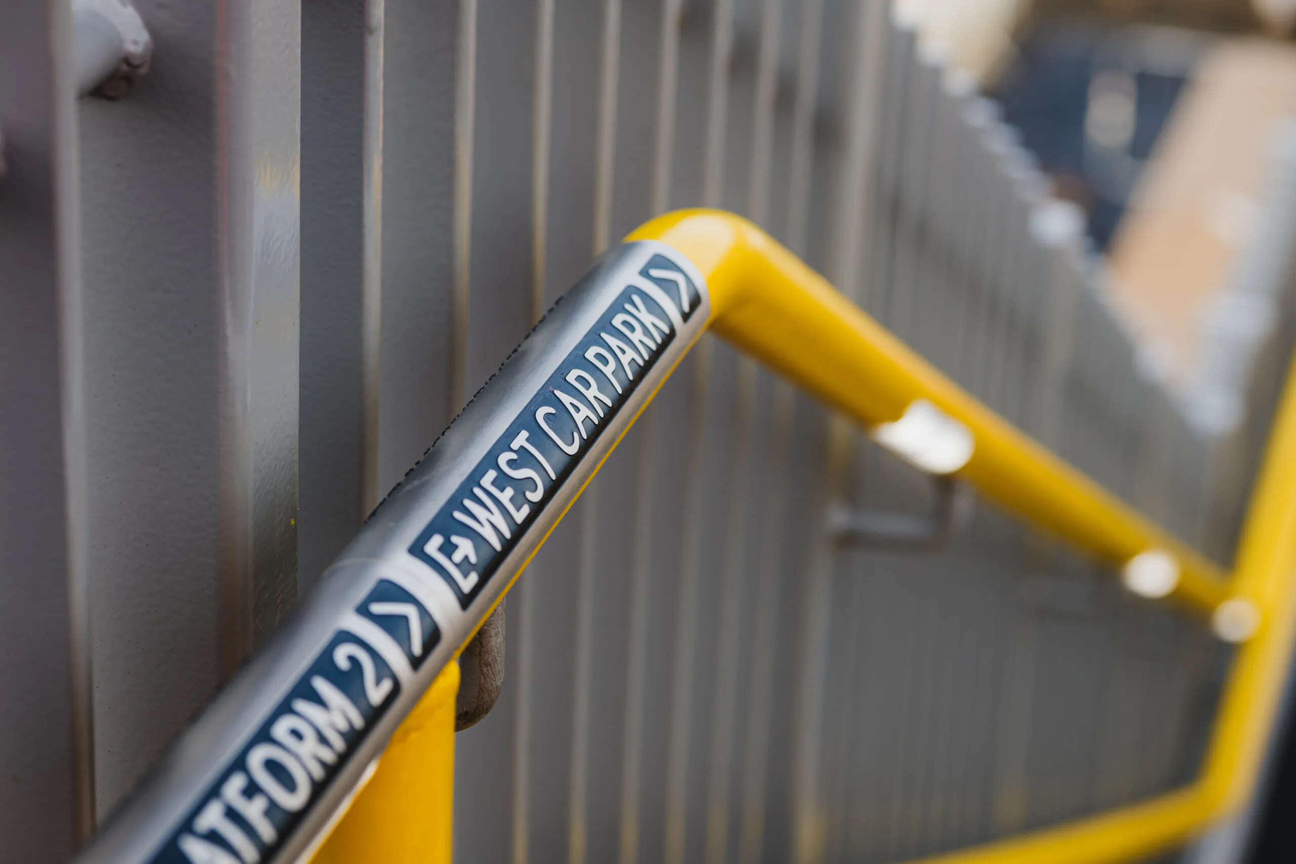Worker in high-visibility clothing inspecting or working on a steel structure at a construction site.