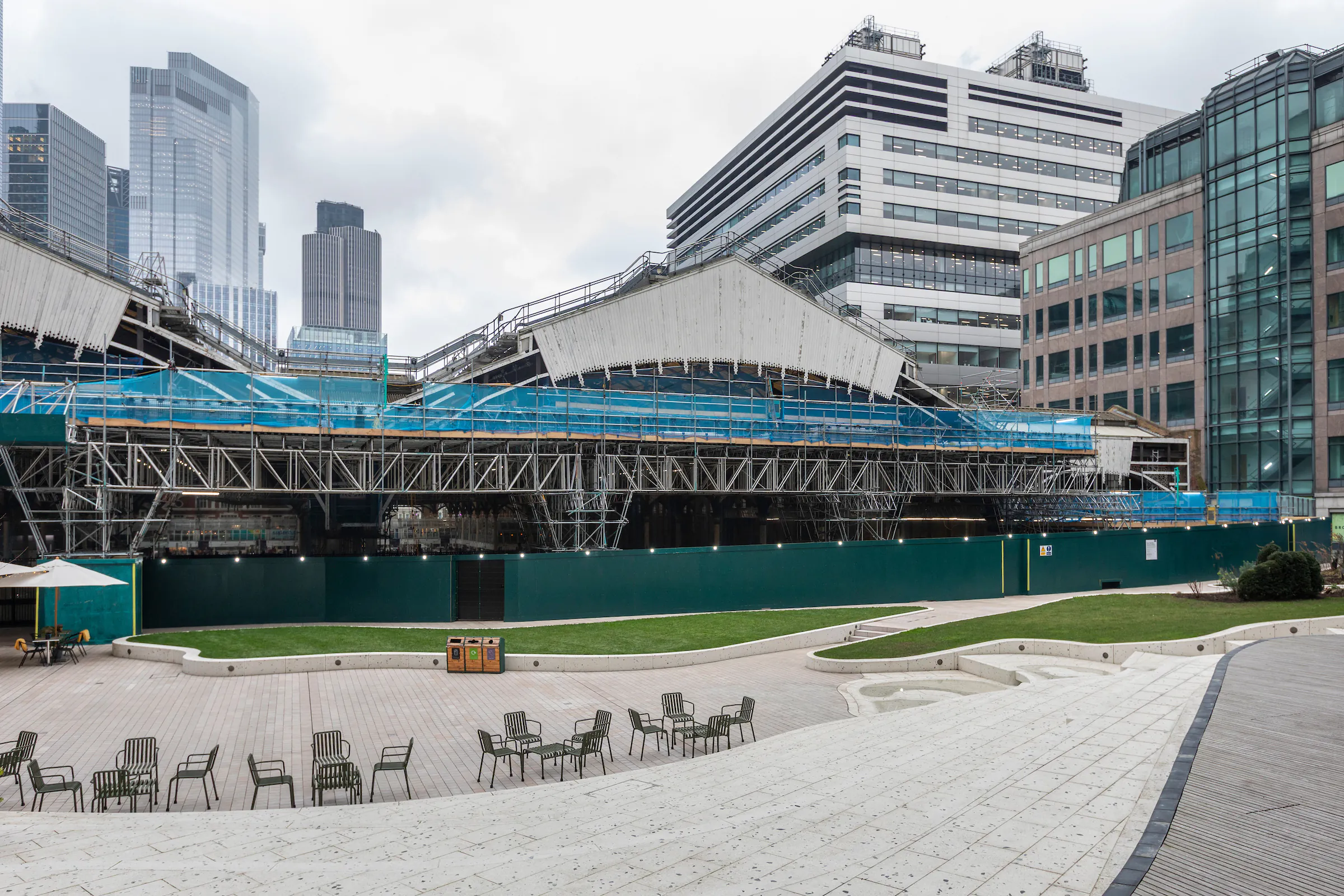 Exterior view of a building surrounded by scaffolding for renovation within an urban setting.
