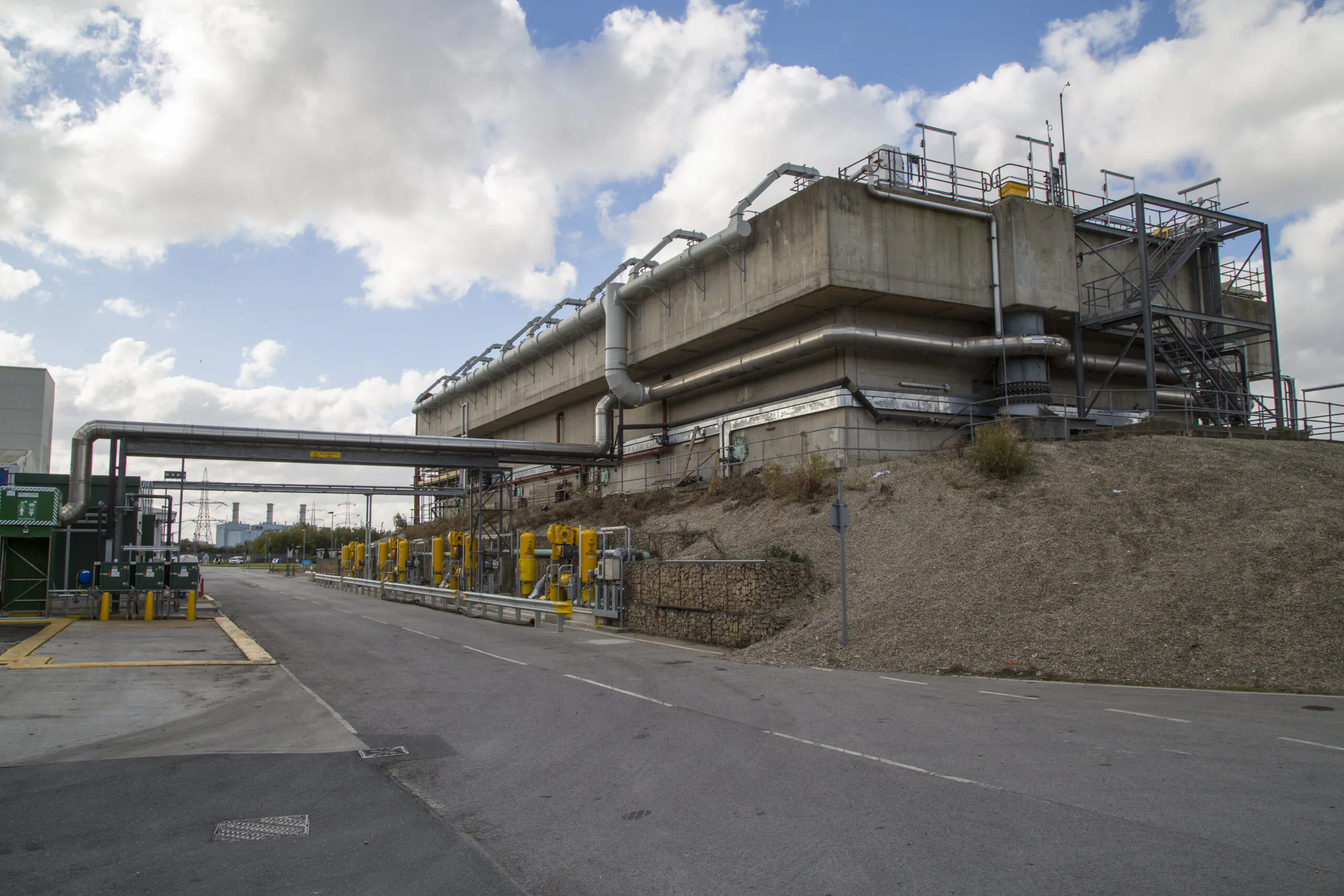 Exterior view of a modern industrial facility with infrastructure and equipment related to energy or utilities.