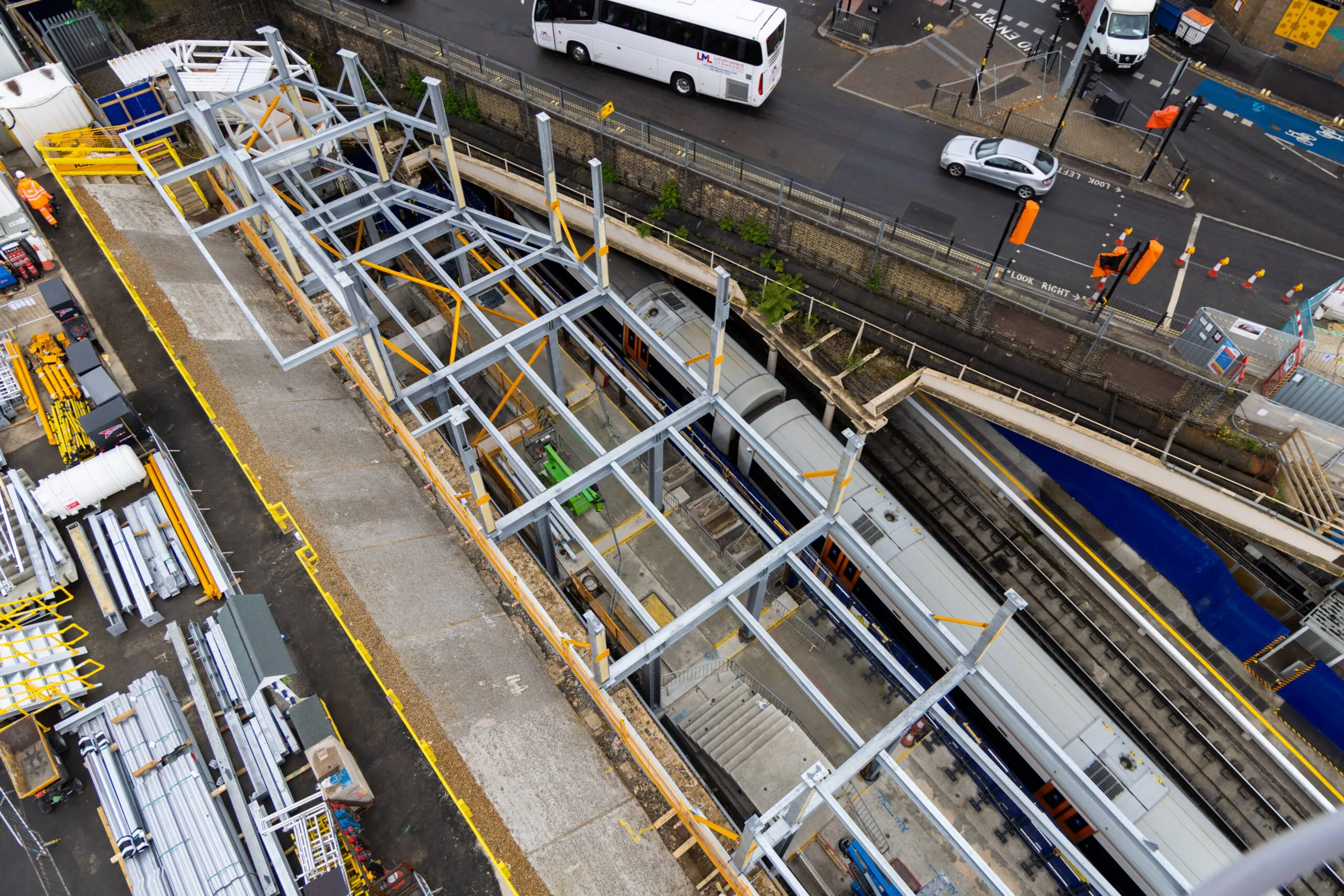 Aerial view of an urban construction site surrounded by busy roads.