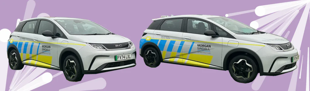 Side view of a Morgan Sindall electric hatchback-style car against a purple background highlighting its eco-friendly design.