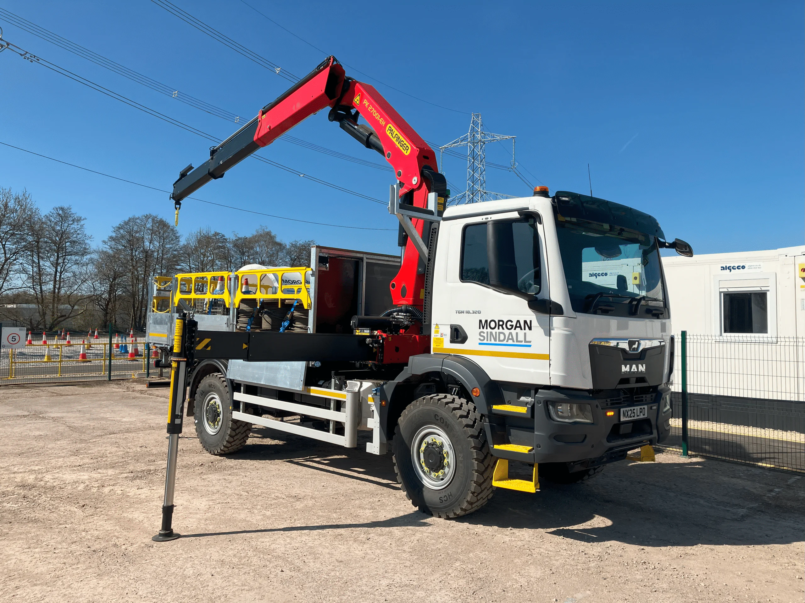 Large truck with a red crane arm and "Morgan Sindall" logo parked at a construction site.