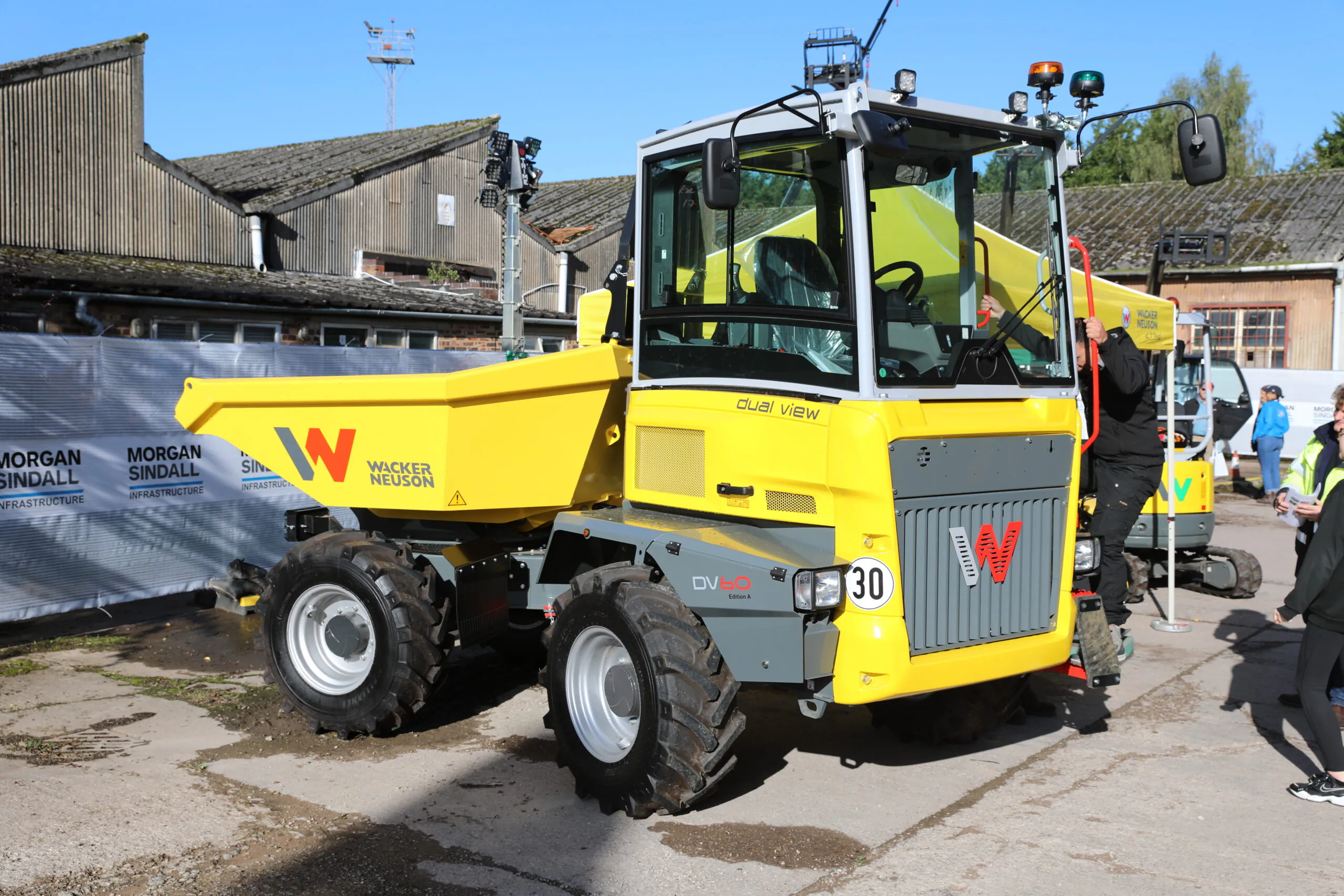 Morgan Sindall electric vehicle parked outdoors, shown from the side with branding and safety markings.