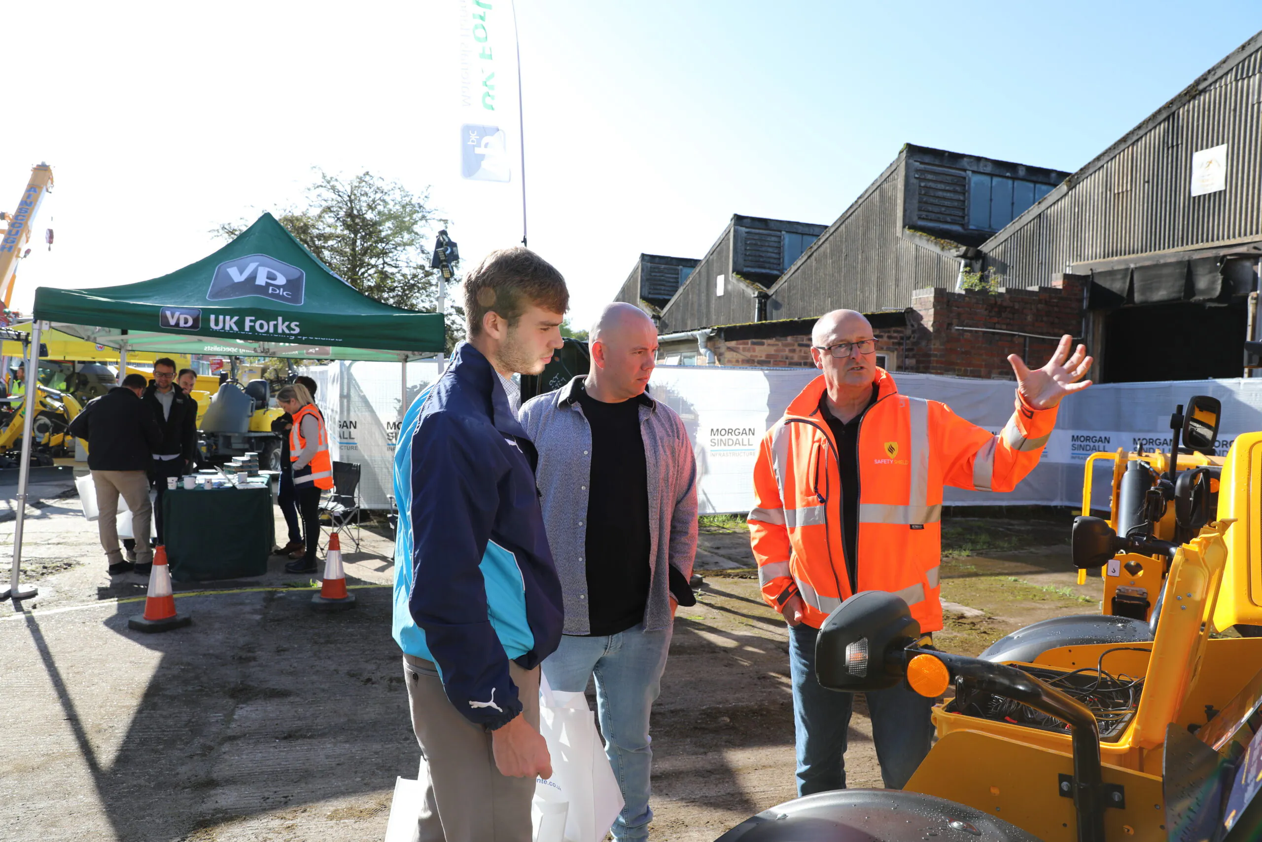 Wider view of the previous scene showing more of the yellow canopy and surrounding construction setup.