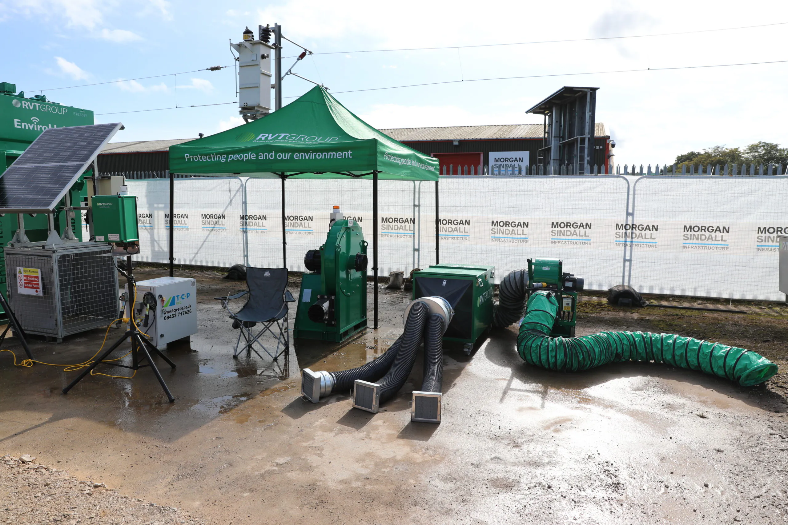 Green RVT Group equipment displayed under a green tent with the slogan "Protecting people and our environment."